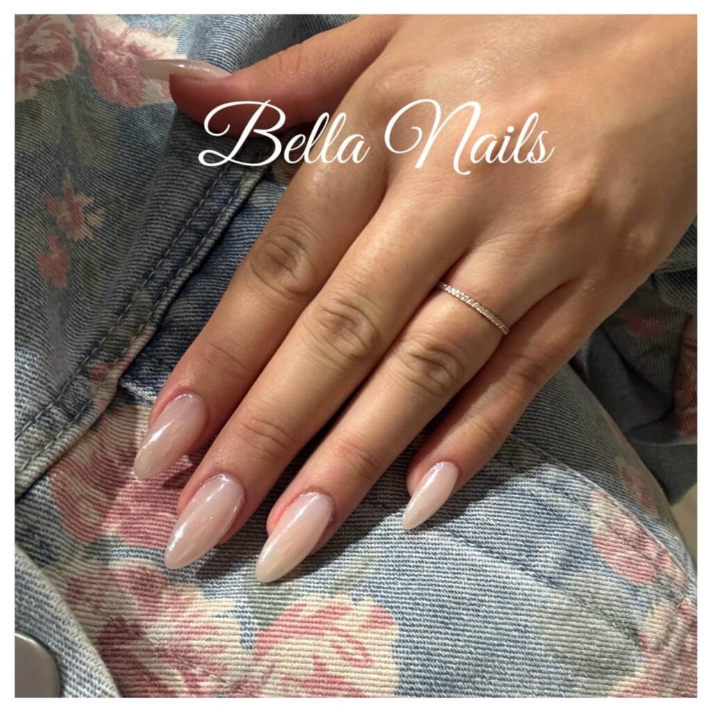 A close-up of nails with small pearl embellishments aligned along the cuticle by bella_nails_annaelle
