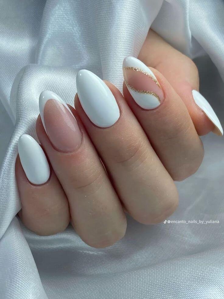 A mix of nude nails with one white nail featuring a gold glitter stripe by nailbeautyguide