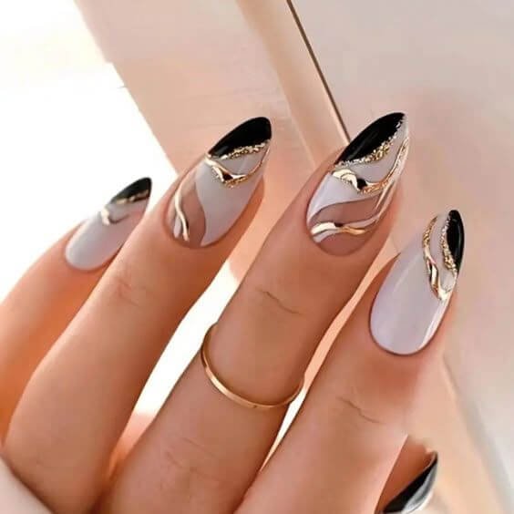 Black and gold lines forming abstract shapes on a matte white background by nailbeautyguide