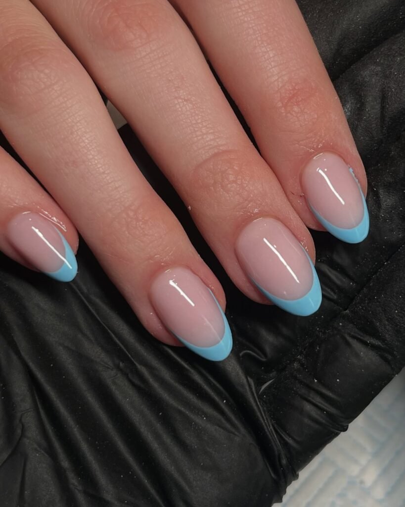 Blue-tipped French with tiny flower accents by _nailsbymai