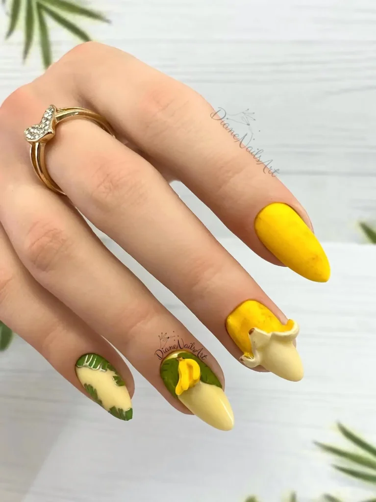 Curved banana yellow nails with tropical fruits by nailbeautyguide