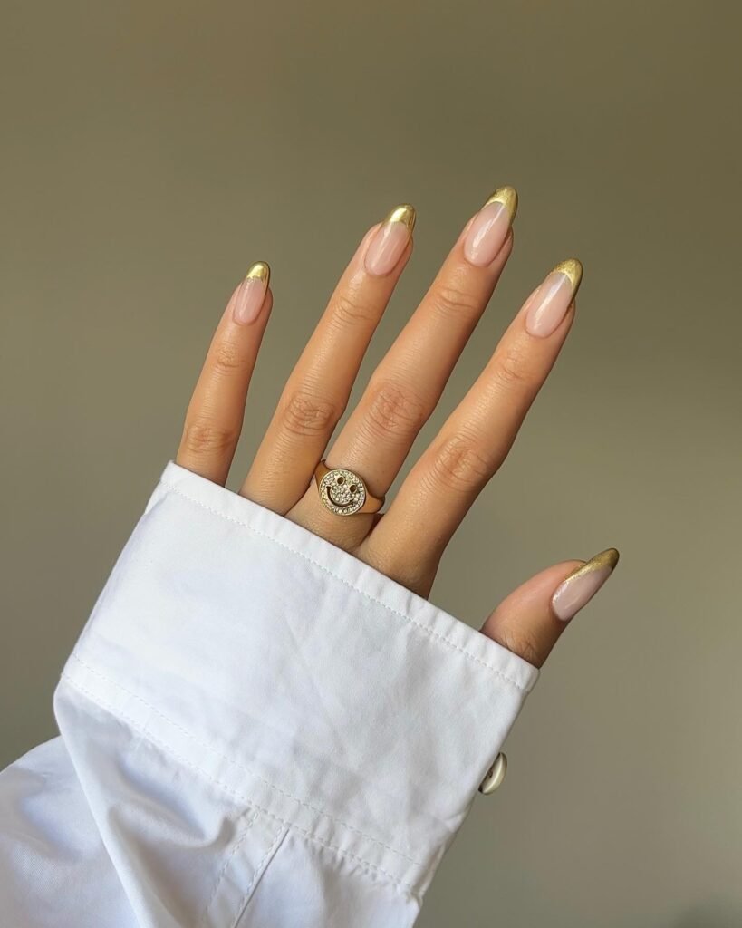 Gold chrome tips with sparkling star decorations by nailsbyalsn