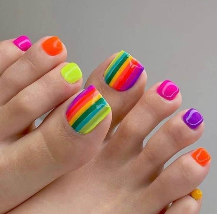 Magical shot of holographic toe nails creating rainbow prism effects under different colored lighting. by nailbeautyguide
