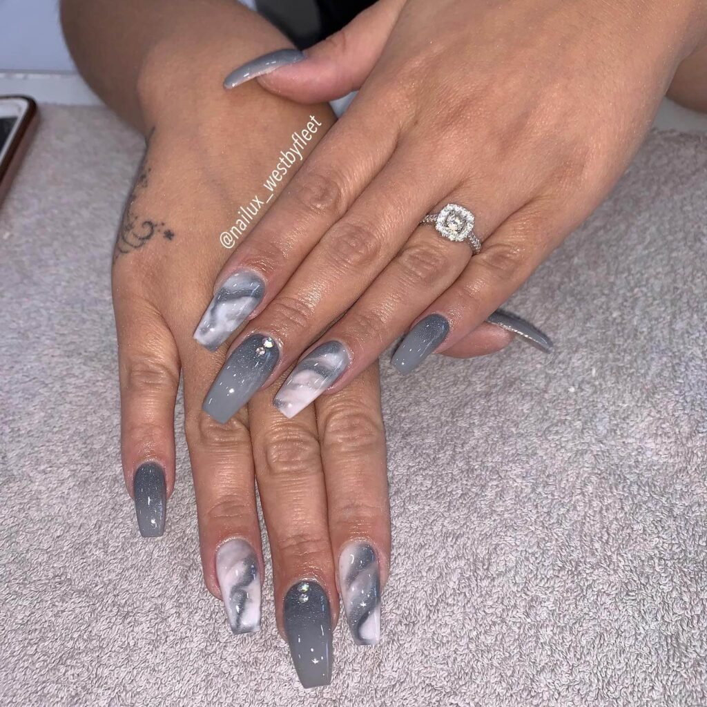 Marble effect nails with gold veining by nailux_westbyfleet