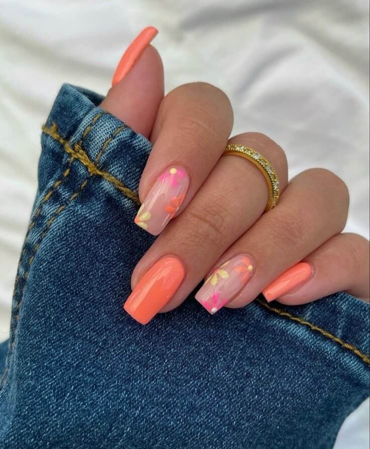 Matte coral nails with floral designs by nailbeautyguide
