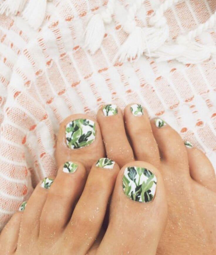  Natural shot of green leaf-pattern toe nails surrounded by real tropical plants and natural sunlight. by nailbeautyguide