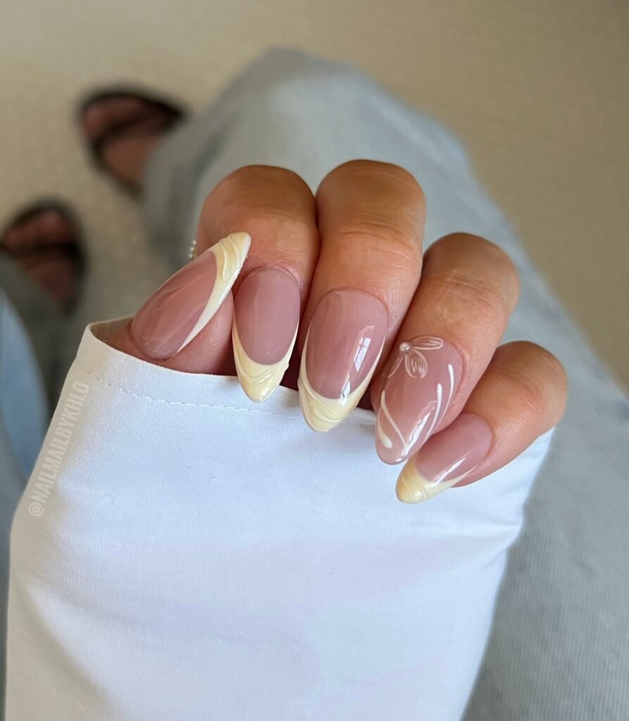 Pale pastel yellow manicure with flower decorations by nailmailbykhlo