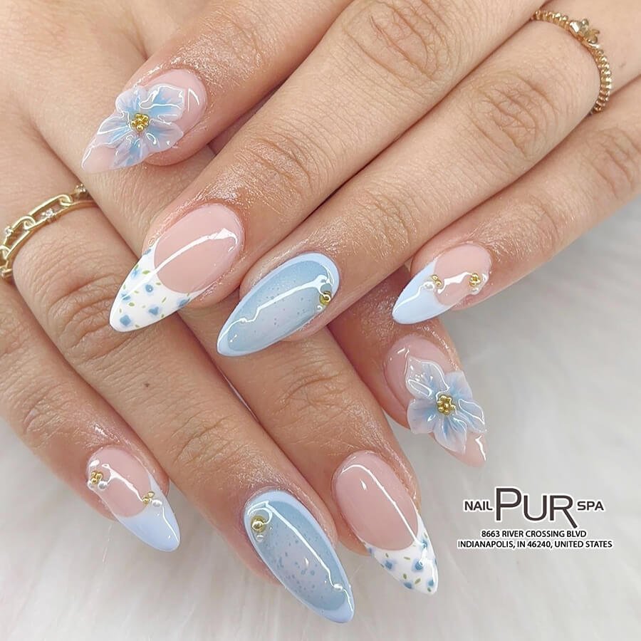 Powder blue nails with dainty floral patterns by purnail.s