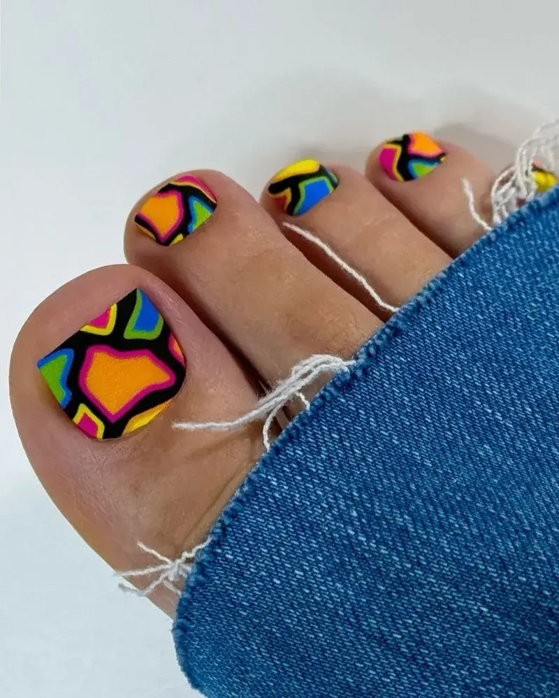 Retro-styled image of geometric wave toe nails with vintage props and neon lighting effects. by nailbeautyguide