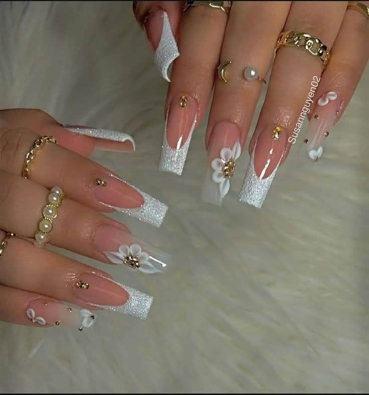 Rhinestones forming a small crown design on glossy white nails by nailbeautyguide