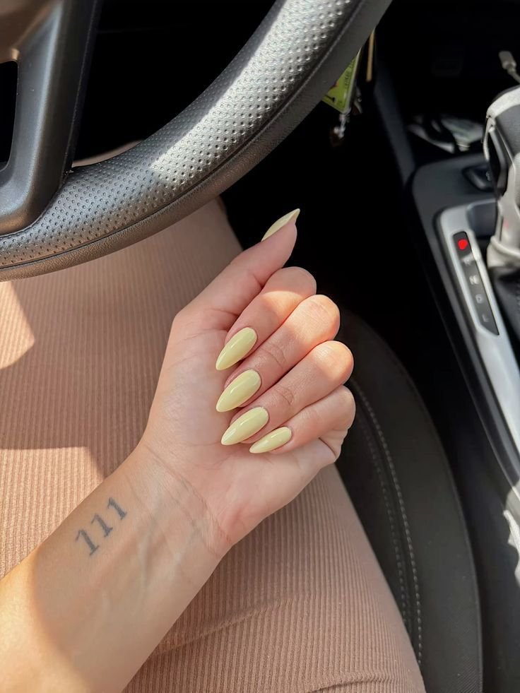 Soft pastel yellow nails with a matte finish by nailbeautyguide