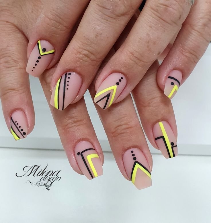 Yellow nails with black geometric line designs by nailbeautyguide