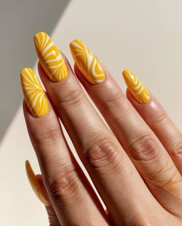 Yellow nails with lace-like designs by nailbeautyguide