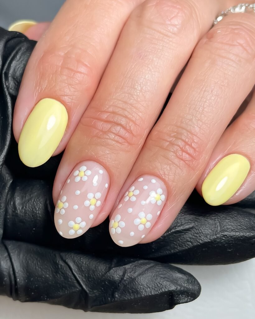Yellow nails with white and pink flower paintings by bysarahnailartist