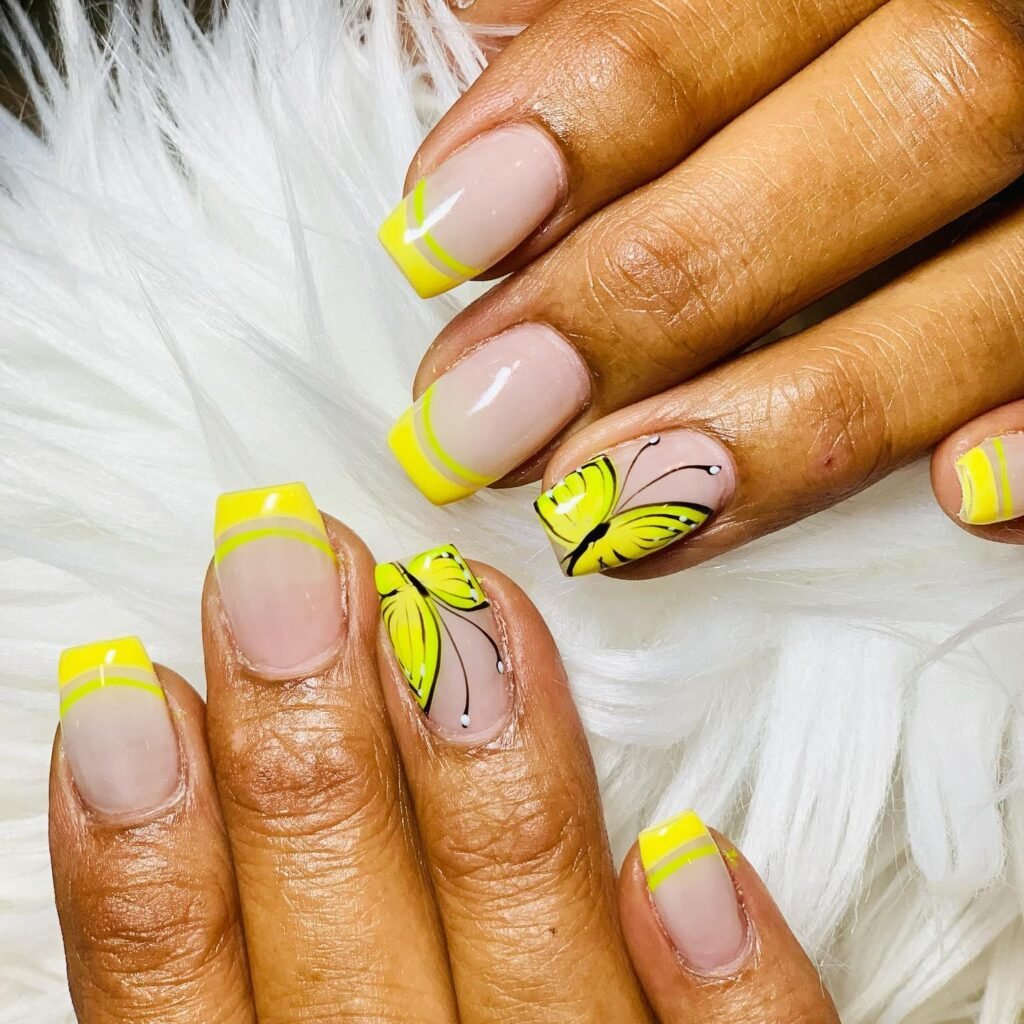 Yellow tips with gradient effects and butterfly details by nailbymara