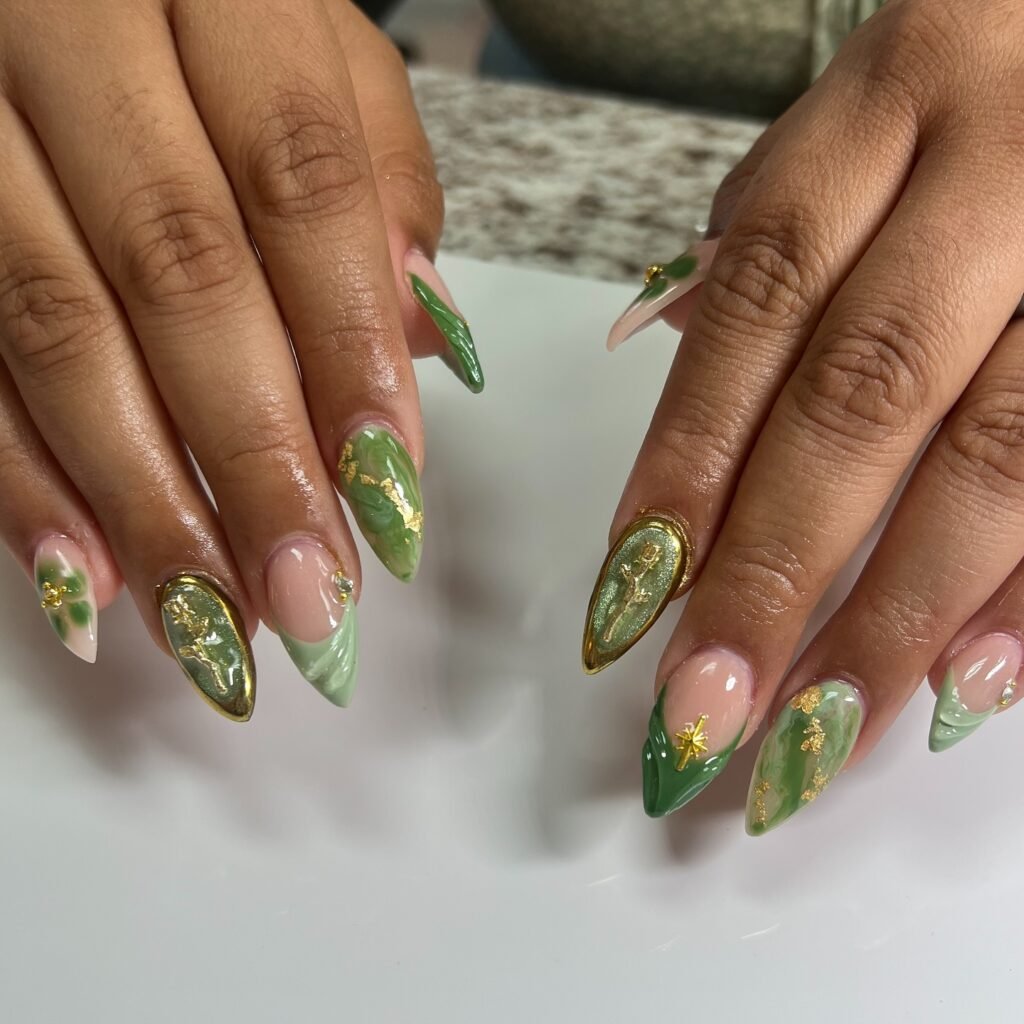 A manicure with sage nails highlighted by delicate gold stripes or tips by vee.nailed.it
