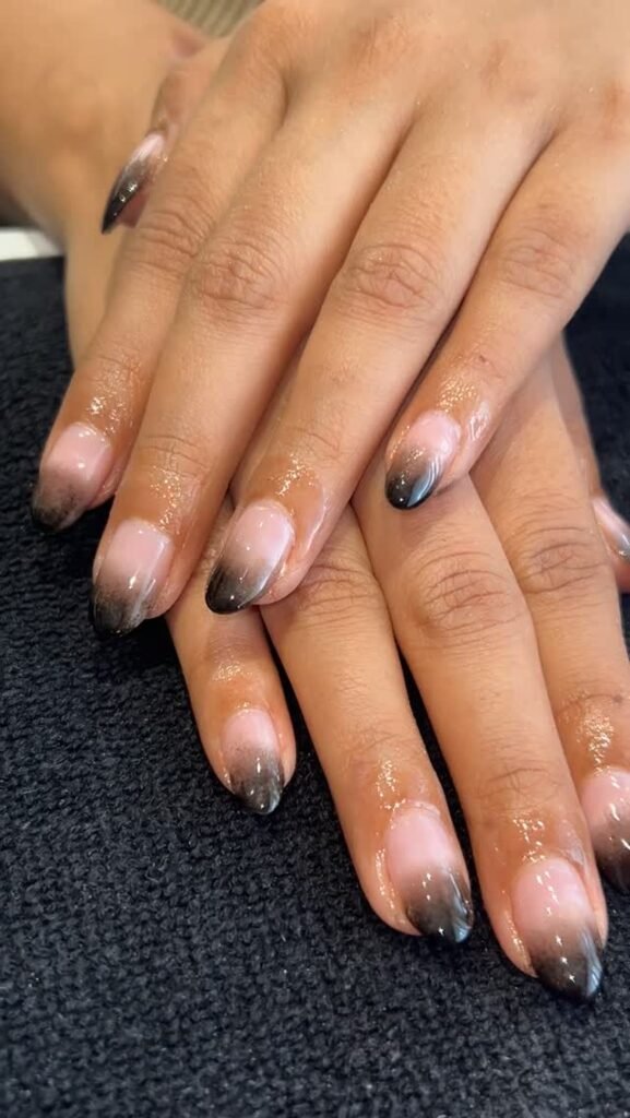Almond-shaped nails with nude-to-black fade by priyanka_nails_artist