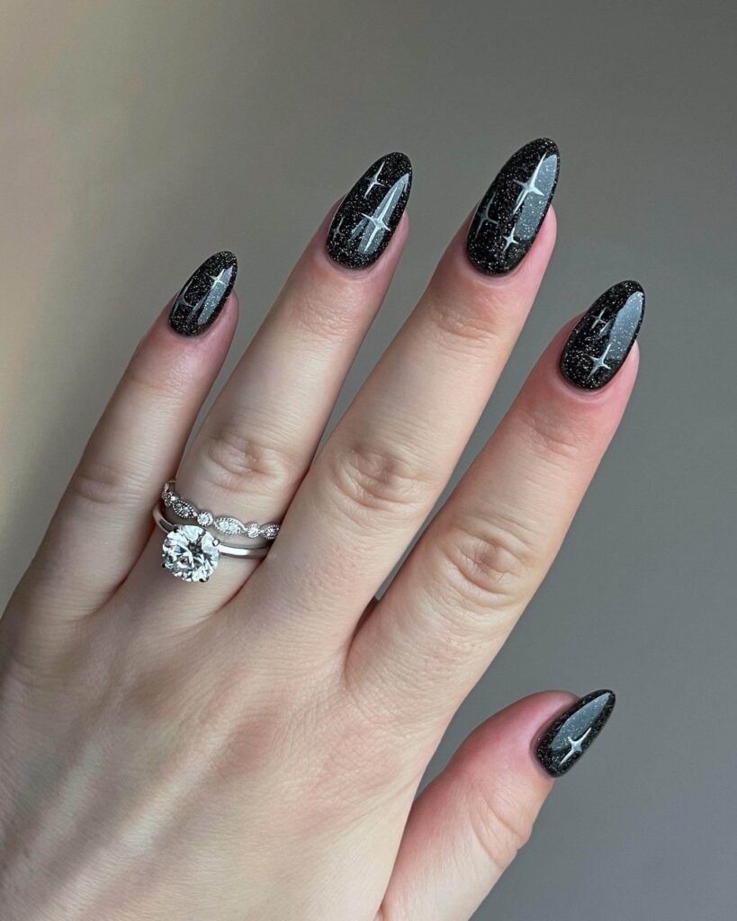 Black October nails with sparkling glitter accents by bugnails