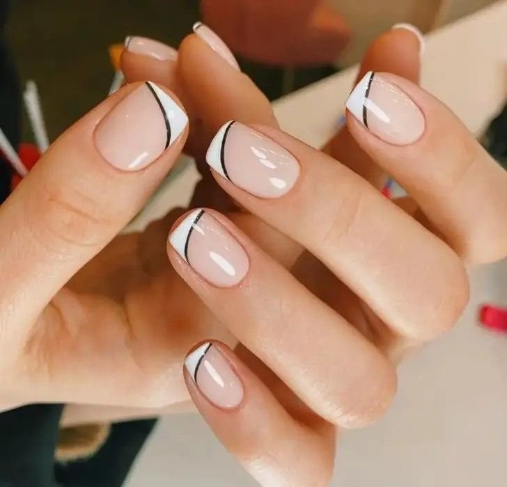 Bold line French tips styled with modern decor by nailbeautyguide