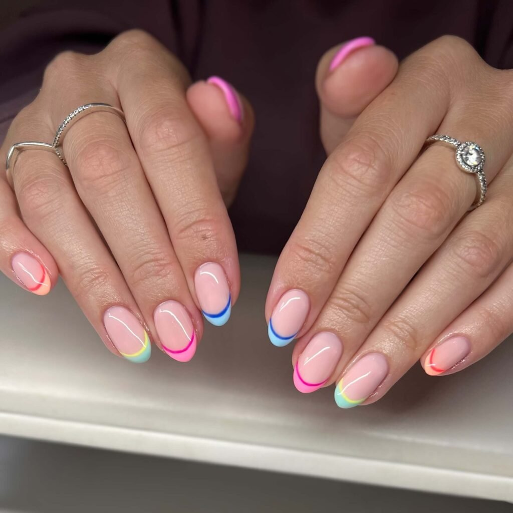 Bright, colorful French tips styled with a summery outfit by nailsbyjess.rose