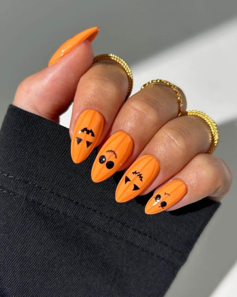 Carved pumpkin face nails by thenaillologist