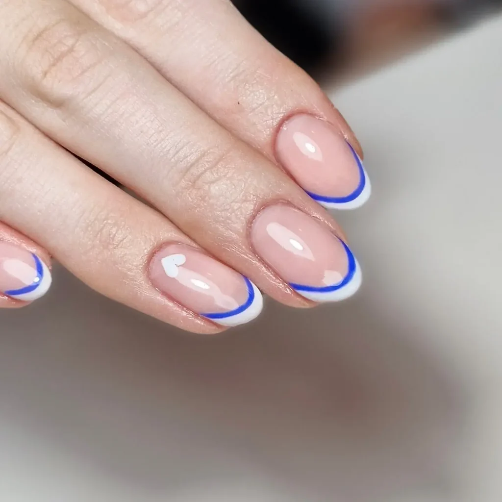Double-line French tips styled with geometric decor by nailsbyhayley.nairn