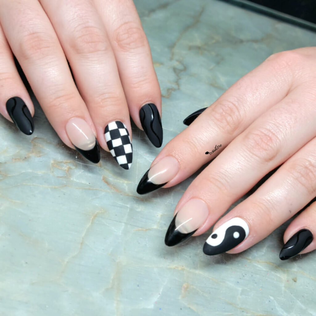 Glossy black tips on extra-long stiletto nails by dznailztho