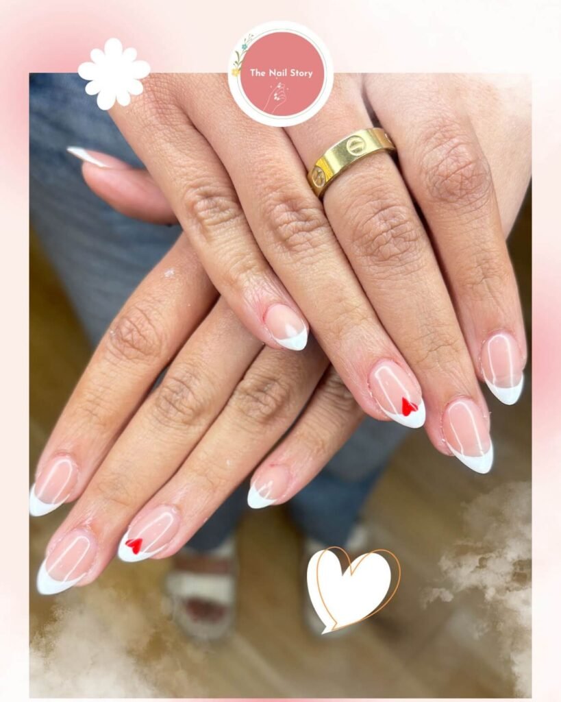 Heart-accented French tips styled with romantic props by thenailstorybhopal