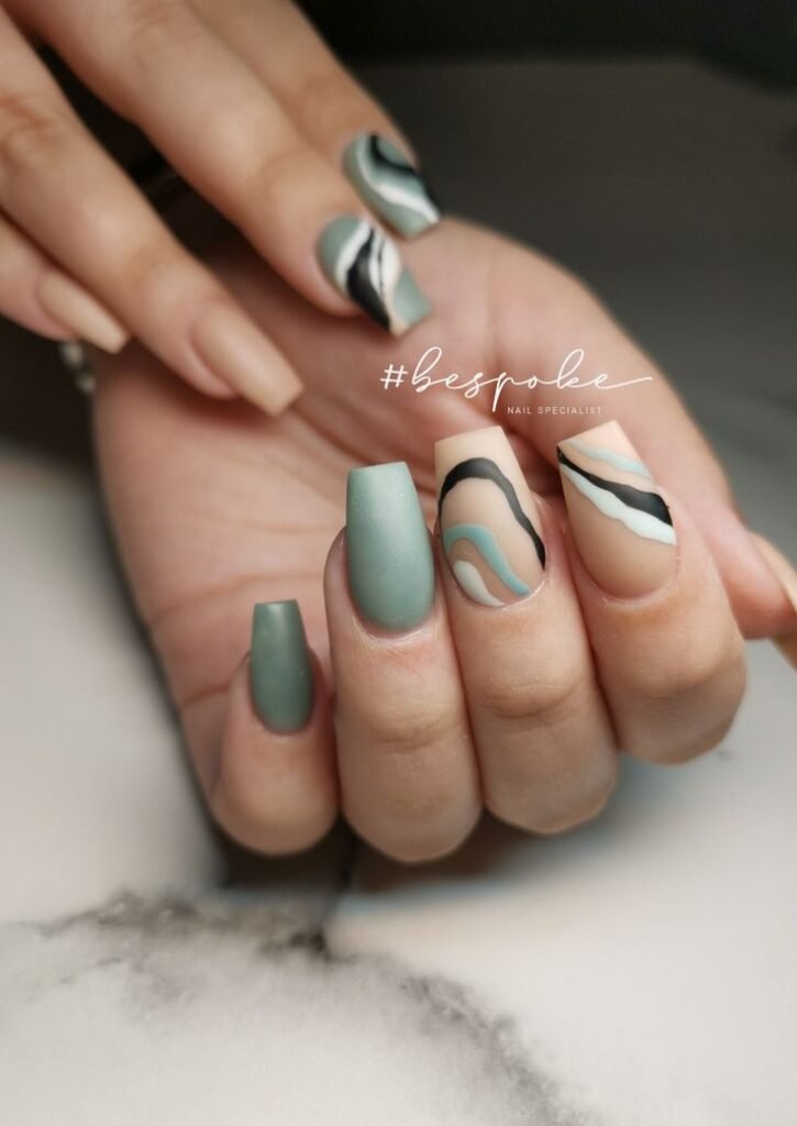Nails half-painted with sage and half with nude, separated diagonally by nailbeautyguide