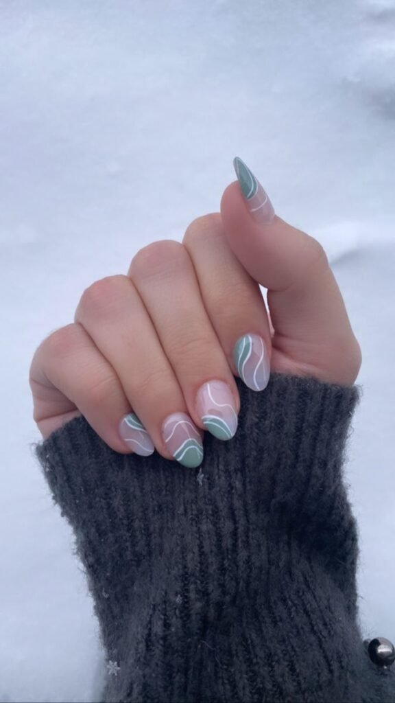 Nails partially painted with sage, leaving sections bare by nailbeautyguide