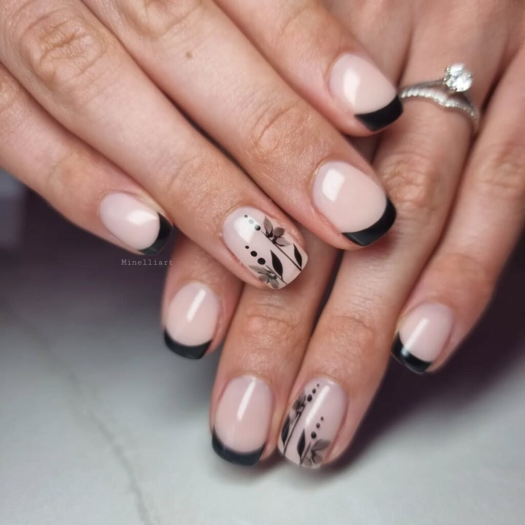 Nude nails with black tips and hand-painted white flowers by minelliart
