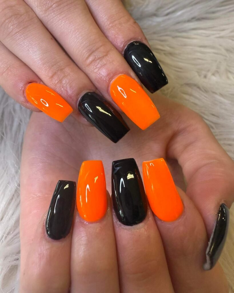 Orange and black October nails for Halloween vibes by slayruby13