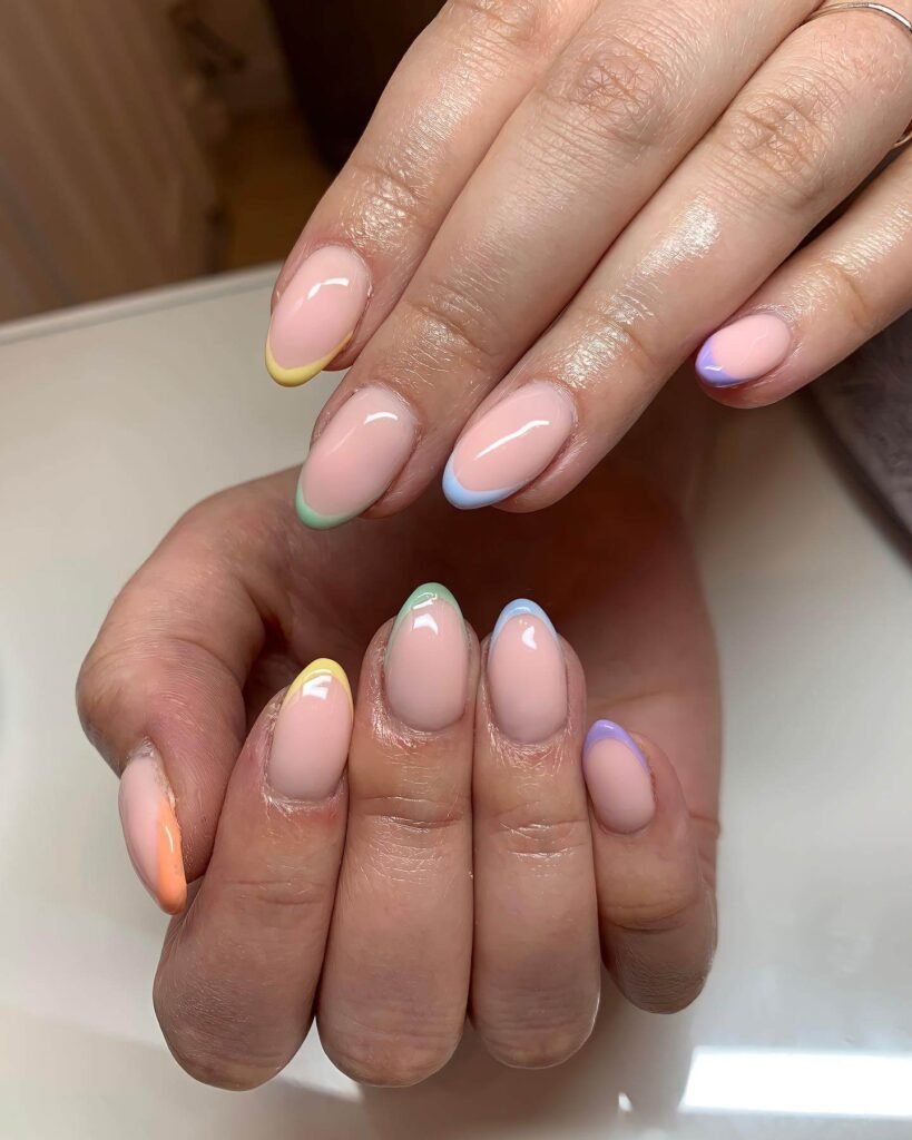 Pastel French tips styled with soft floral props by ameliamaybeauty