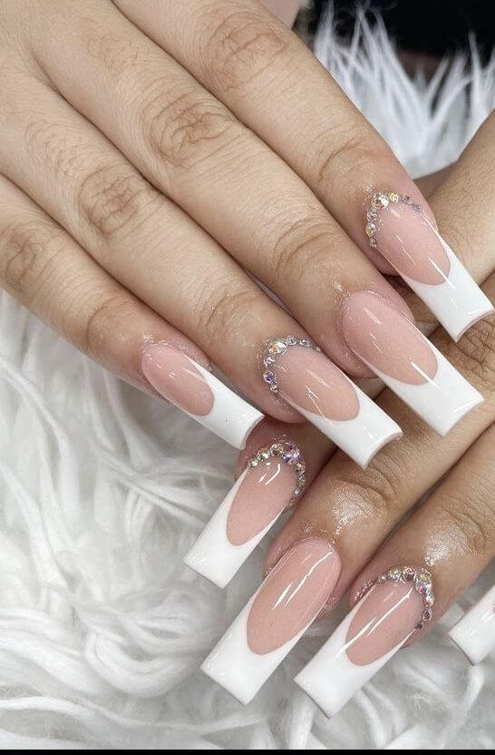 Rhinestone French tips styled with sparkling jewelry by nailbeautyguide