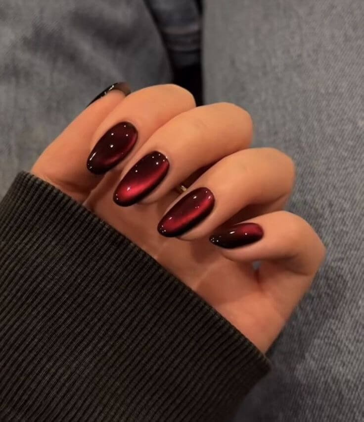 Rich oxblood velvet gel nails, satin finish by nailbeautyguide