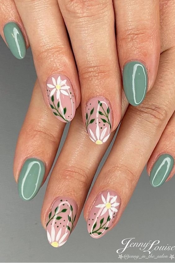 Sage nails decorated with hand-painted white daisies by nailbeautyguide