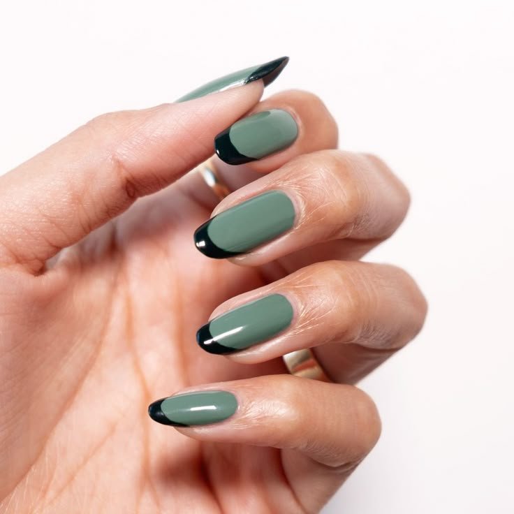 Sage nails decorated with thin black lines or dots by nailbeautyguide