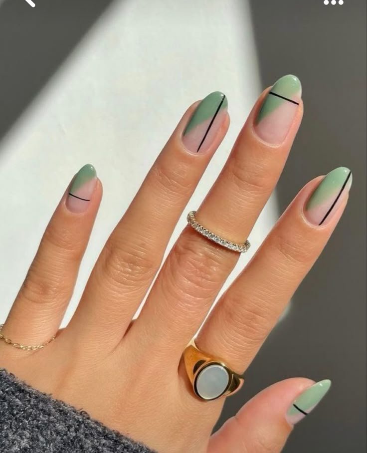 Sage nails featuring bold white or black lines and shapes by nailbeautyguide