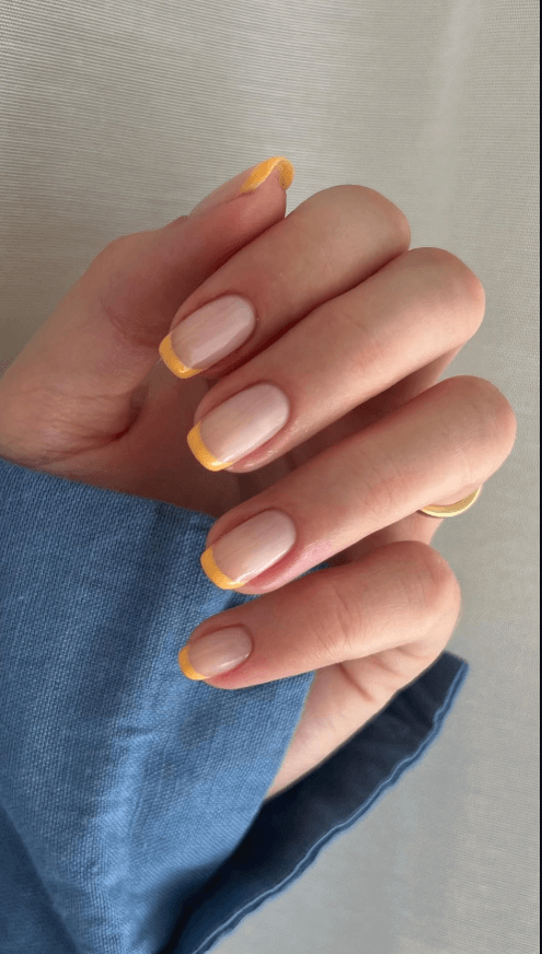 Thin minimalist French tips photographed on a clean background by  amberjhnails
