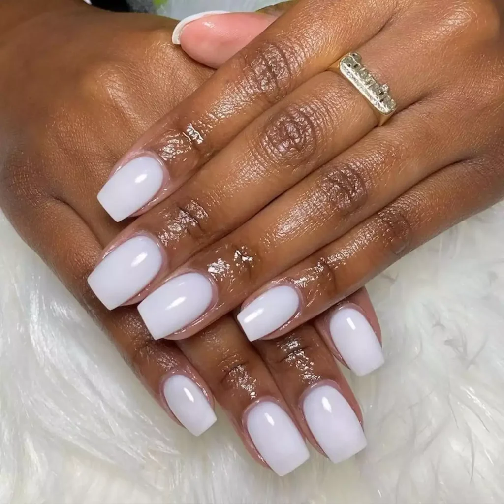 A milky-white or creamy white dip powder manicure on medium-length nails by nails_art_by_noren