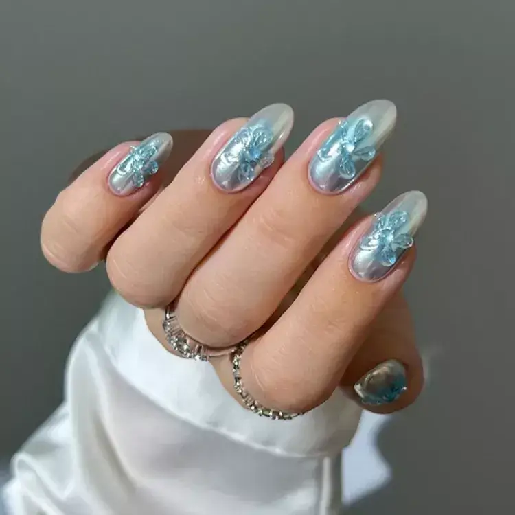 Blue chrome nails with retro flower and pixel art designs. by heygreatnails