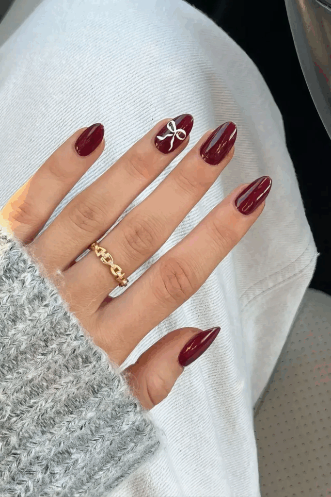 Deep Cherry Mocha Nails with Coquette Bow Accents by nailbeautyguide