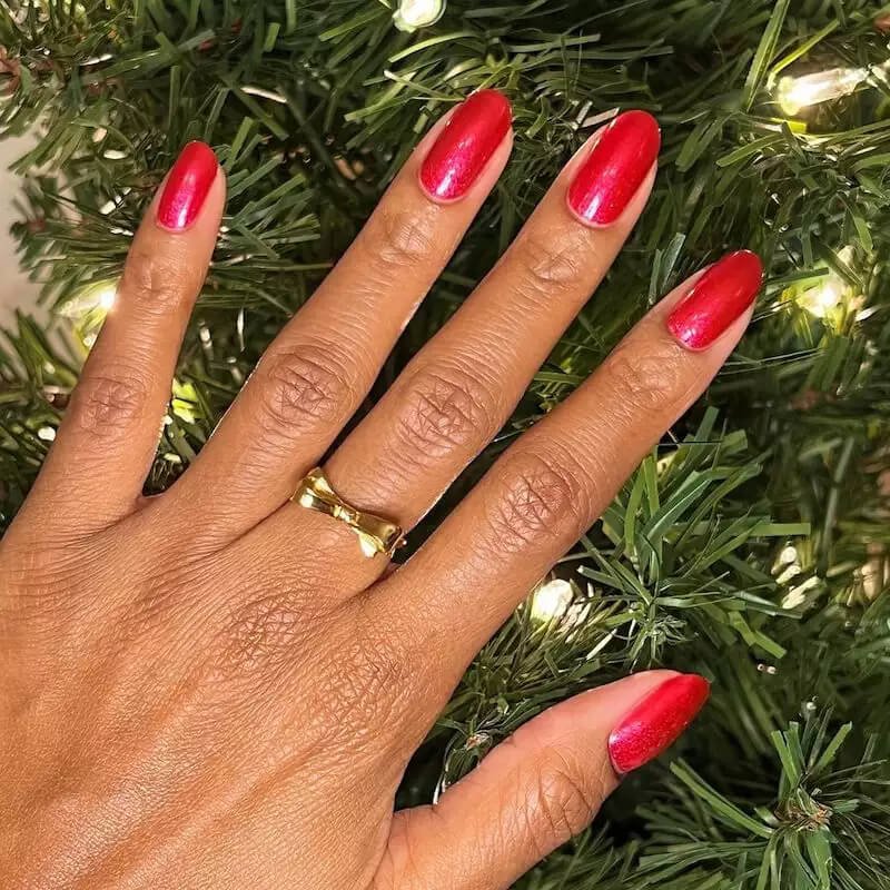 Fingernails painted with a vibrant, true classic cherry red nail polish by oliveandjune