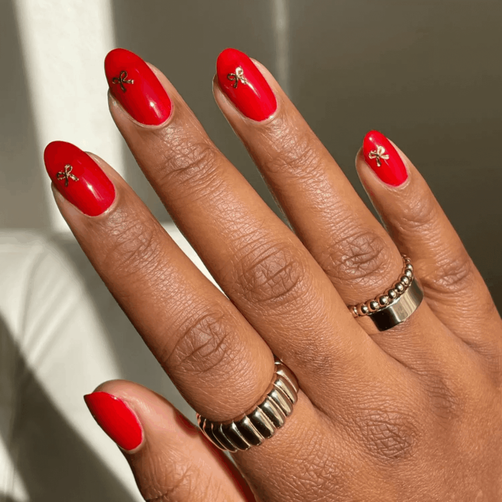 Glossy Red Nails with Small Golden Bow Decals Christmas by melanated.mani