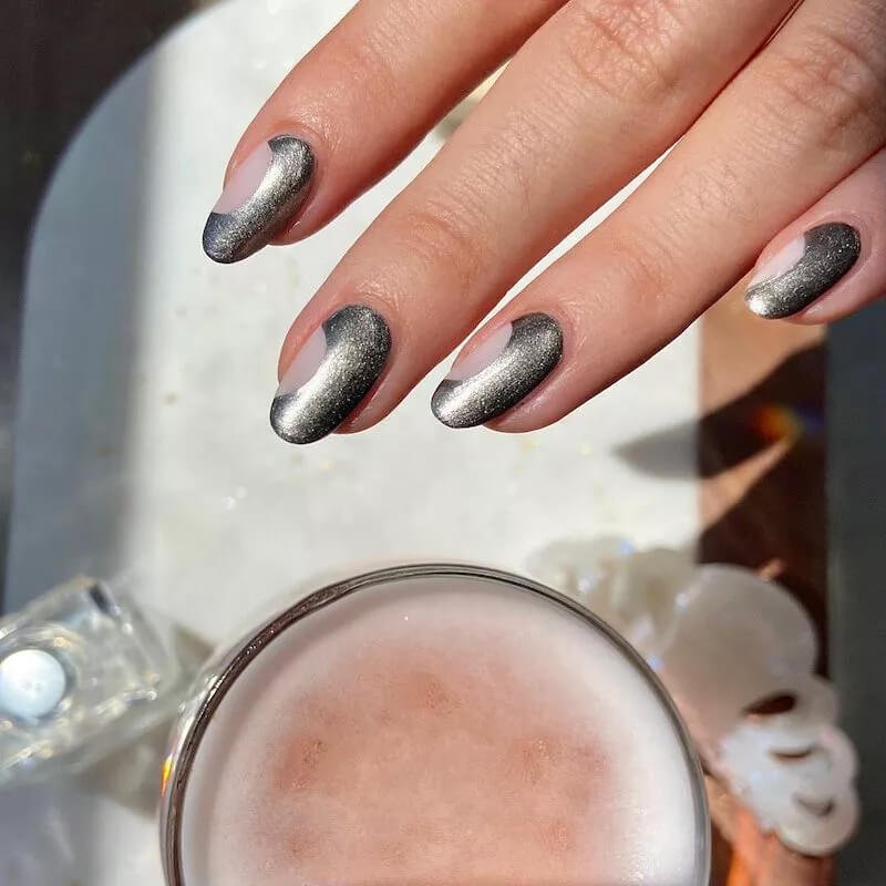 Manicured nails painted with a highly reflective, high-shine silvery chrome finish by paintboxnails