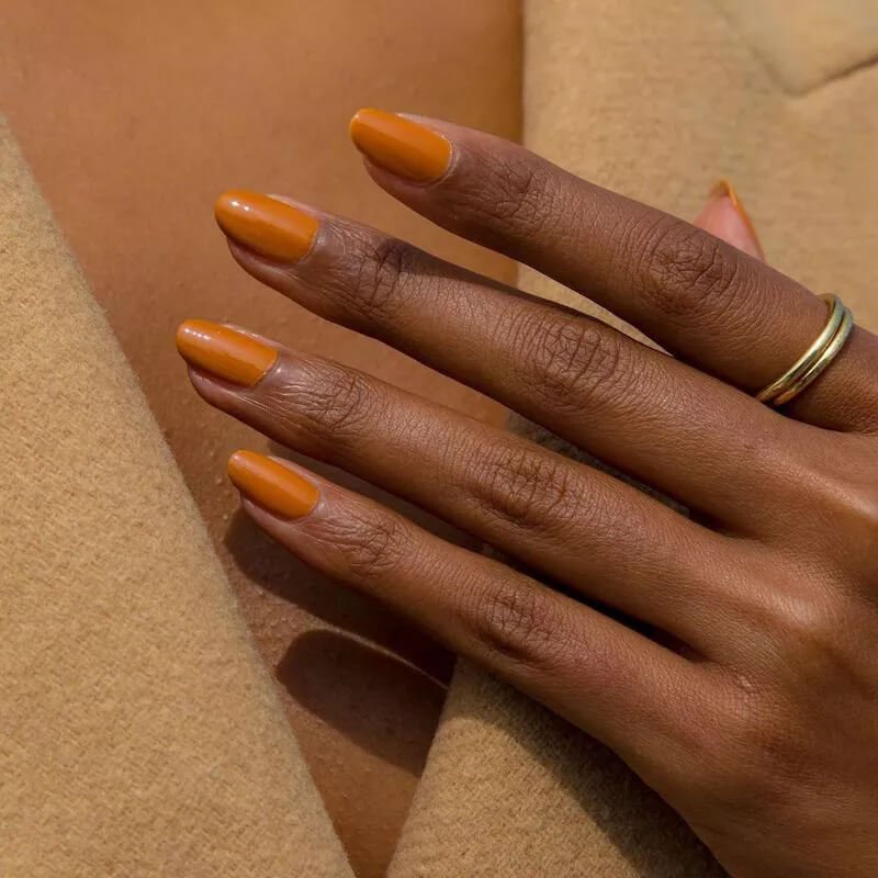 Manicured nails with a warm sandstone orange polish, similar to terracotta by paintboxnails