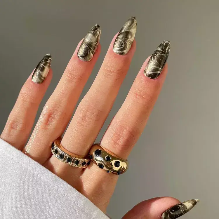 Marbled metallic nails with a molten, chrome-like finish. by phoebesummernails
