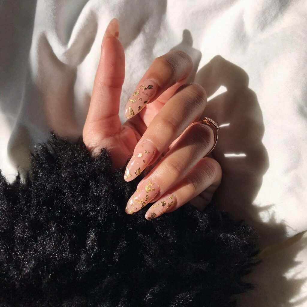 Nails with a glamorous, metallic gold foil accent on the tips or across the nail by ashlydanielaa