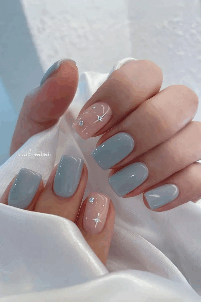 Shimmering Icy Blue Nails with Rhinestone Accents by nail_mini