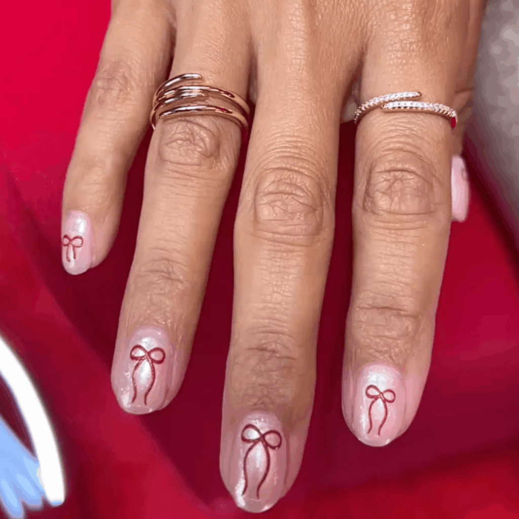 Soft Pink Nails with Bold Red Bow Nail Art by ginaedwards_